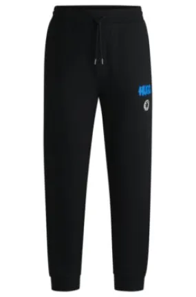 Cotton-terry tracksuit bottoms with Happy HUGO logo